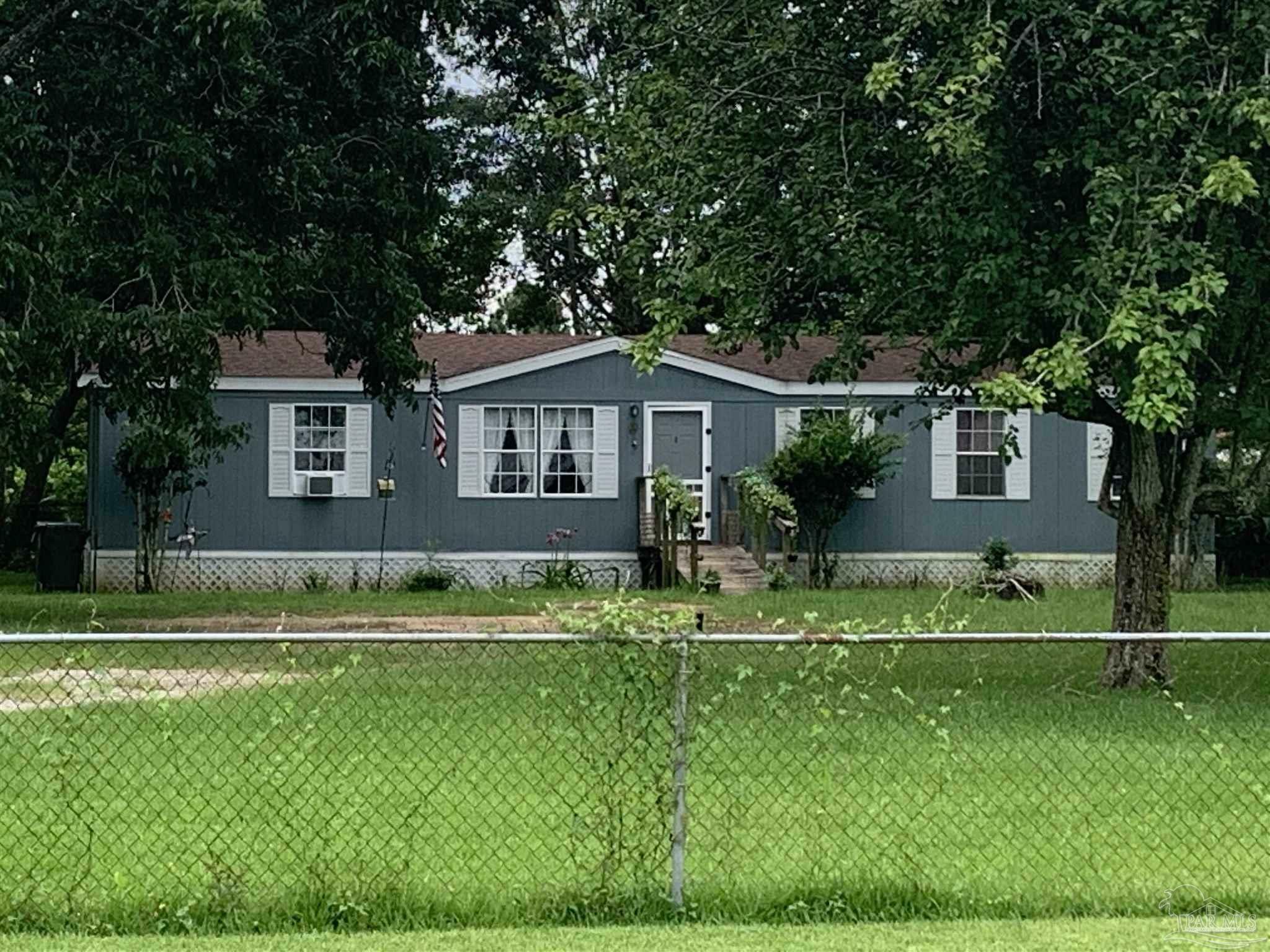 Property Photo:  1119 Muscogee Rd Mobile Home At Back Of Property  FL 32533 