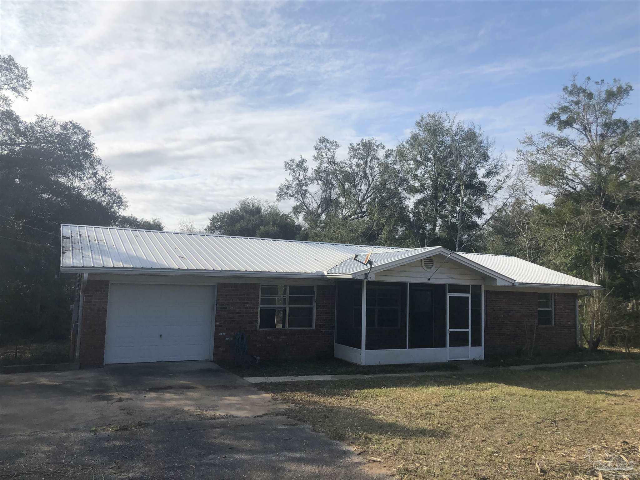 Property Photo:  7569 Woods Rd  FL 32526 